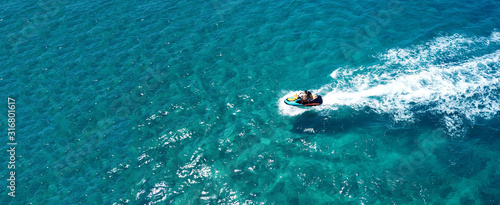 Canvas Print Aerial drone ultra wide photo of jet ski couple cruising in high speed in tropic