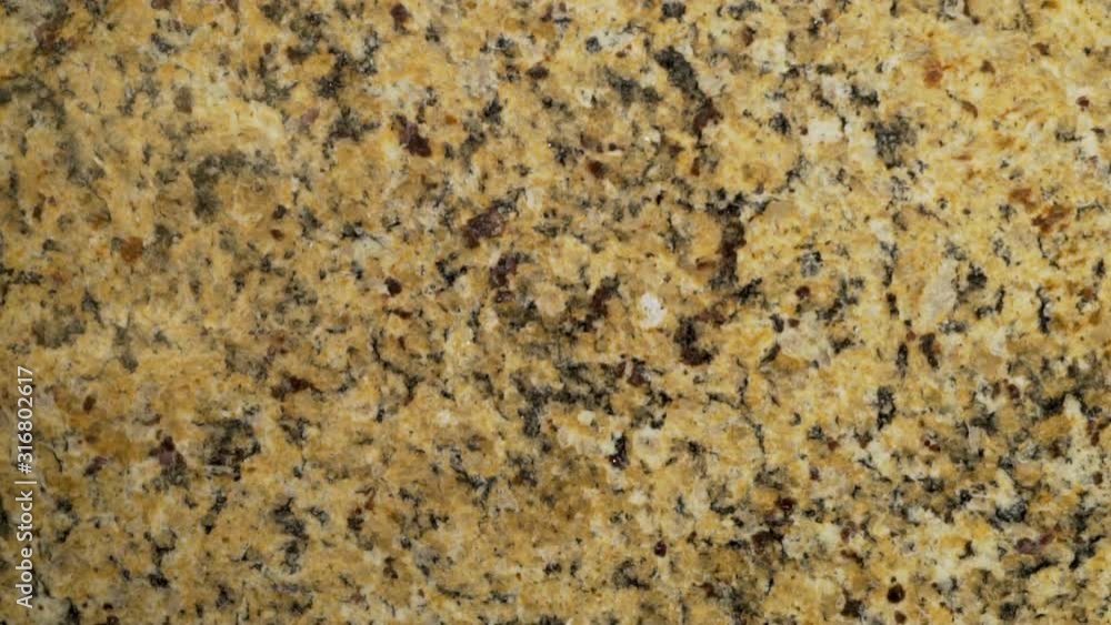 Stone granite surface with beige white dark brown inclusions in a modern design for finishing the kitchen, bathroom, interior decoration. Stone granite surface with beige white dark brown inclusions in a modern design for finishing the kitchen, bathroom, interior decoration.