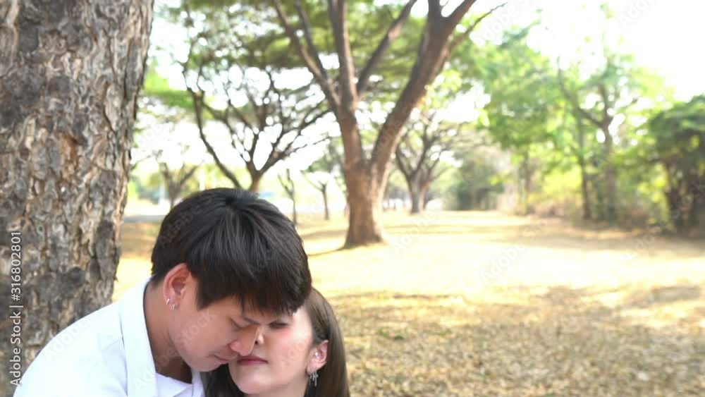 Portrait of young asian couple in love in the forest,Thailand people happy to be together,Valentine day concept Portrait of young asian couple in love in the forest,Thailand people happy to be together,Valentine day concept