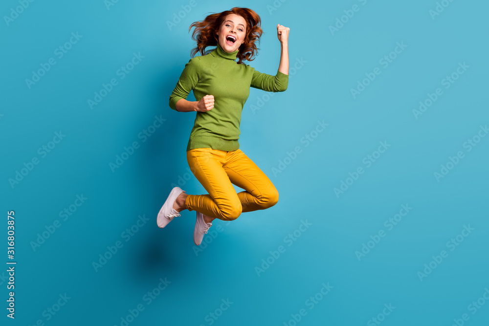 Full length body size view of nice attractive cheerful cheery wavy-haired girl jumping enjoying life having fun rejoicing isolated on bright vivid shine vibrant blue teal turquoise color background