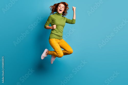 Full length body size view of nice attractive cheerful cheery wavy-haired girl jumping enjoying life having fun rejoicing isolated on bright vivid shine vibrant blue teal turquoise color background