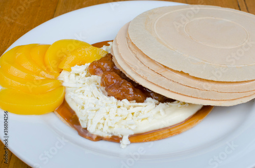 Wafer, traditional Colombian dessert, chopped fruit cookie and sauces