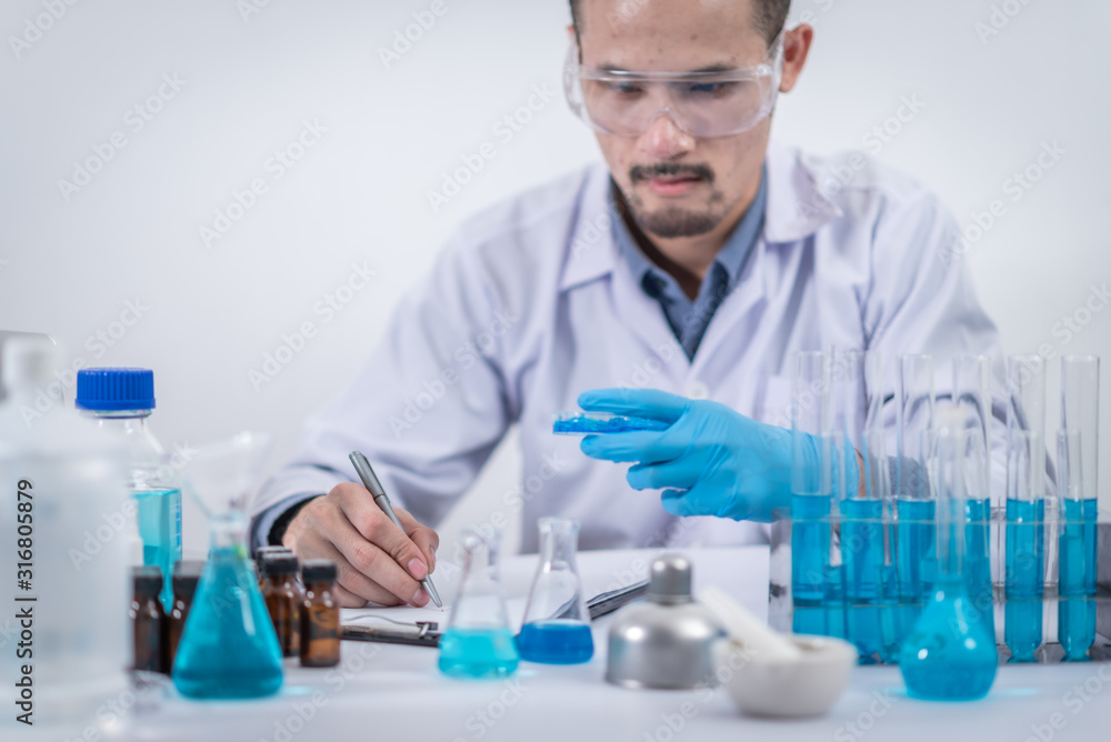 scientist with equipment and science experiments ,laboratory glassware containing chemical liquid for design or decorate science or other your content and selective focus scientist with equipment and science experiments ,laboratory glassware containing chemical liquid for design or decorate science or other your content and selective focus