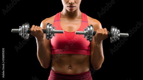 Cropped of athletic woman exercising with barbells