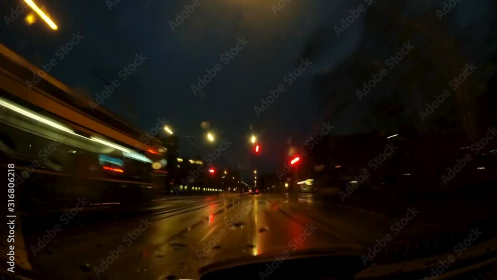 View out of a car driving through the city at a rainy night with reflecting lights and traffic. Time lapse. FPV. View out of a car driving through the city at a rainy night with reflecting lights and traffic. Time lapse. FPV.