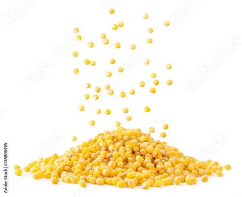 A pile of millet is poured close-up on a white background photo