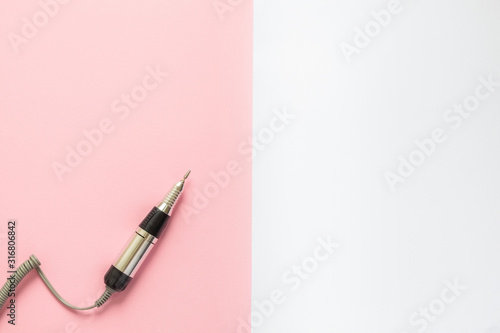 Electric Nail Drill Machine Pen on pink and white graphic background