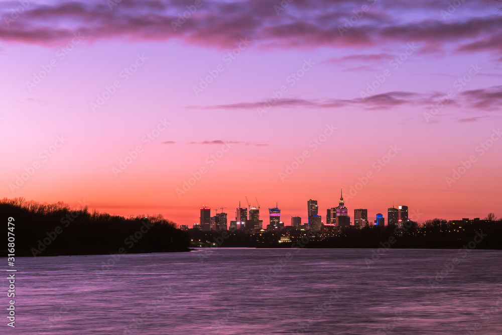 Warsaw skyline with skyscrapers during colorful sunset over the Vistula R
