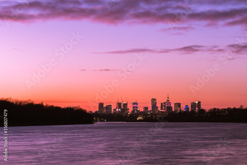 Warsaw skyline with skyscrapers during colorful sunset over the Vistula R photo
