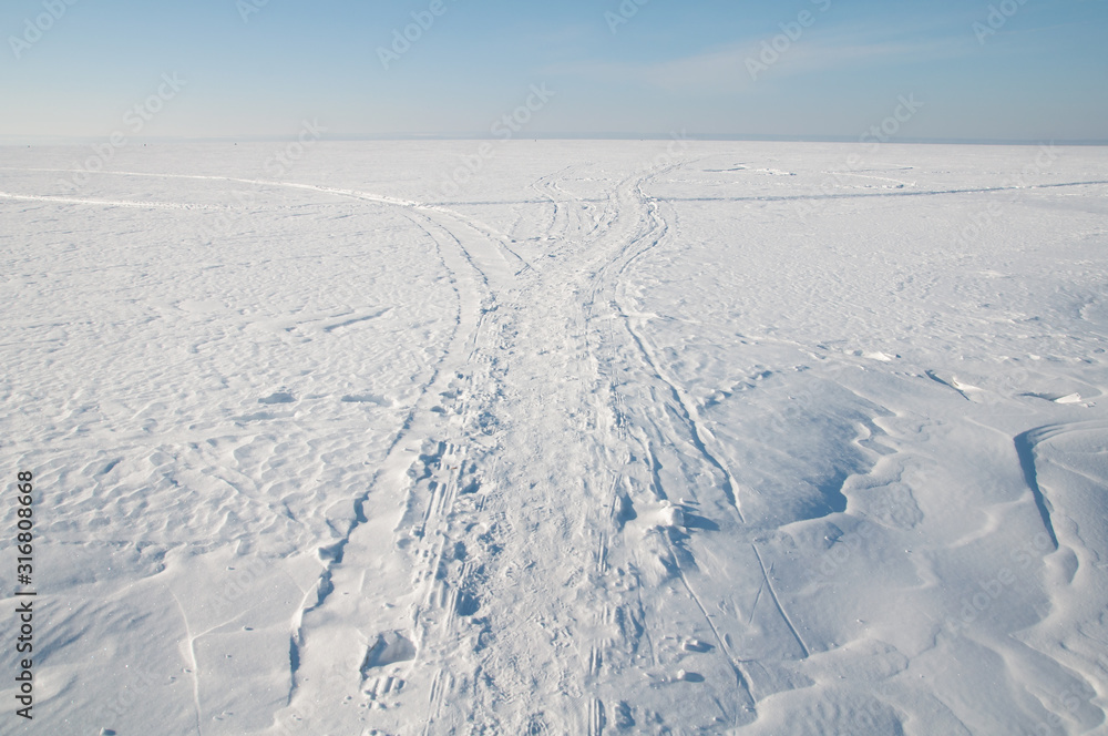 Footprints in the snow, frost, sunny weather.