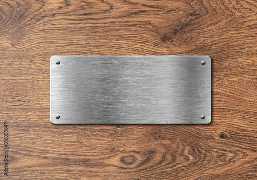 Blank polished silver plate on wooden background to ad text, names or logos