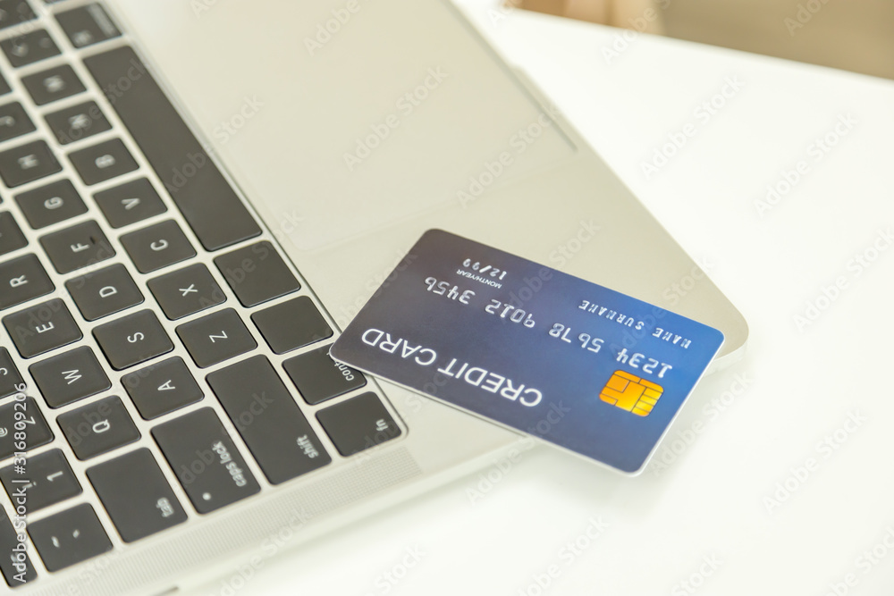 E-Commerce, Online Shopping and Technology Concept. Close up of mock up fake  credit card on laptop computer on white desk. Stock Photo | Adobe Stock