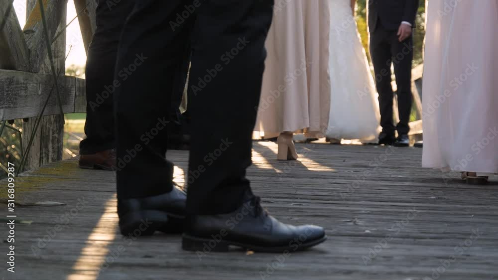 many wedding guests standing together outdoors and enjoying the party many wedding guests standing together outdoors and enjoying the party