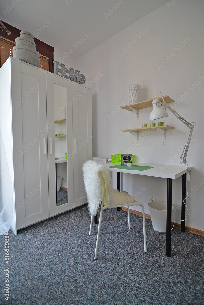 A teenager's room with a study desk.