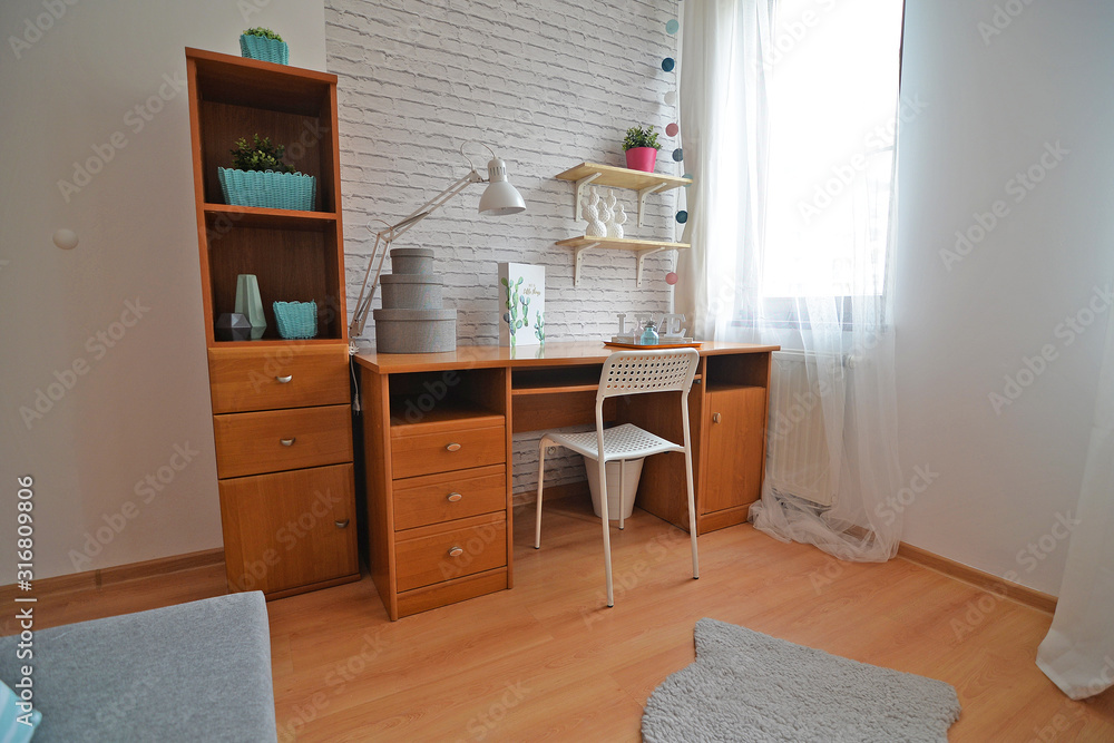 A teenager's room with a study desk.