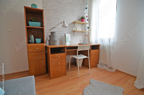 A teenager's room with a study desk.