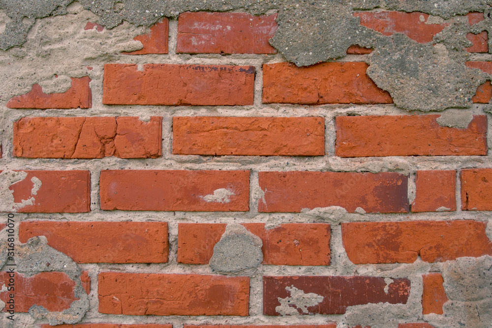 Old brick wall with the remains of plaster Old brick wall with the remains of plaster
