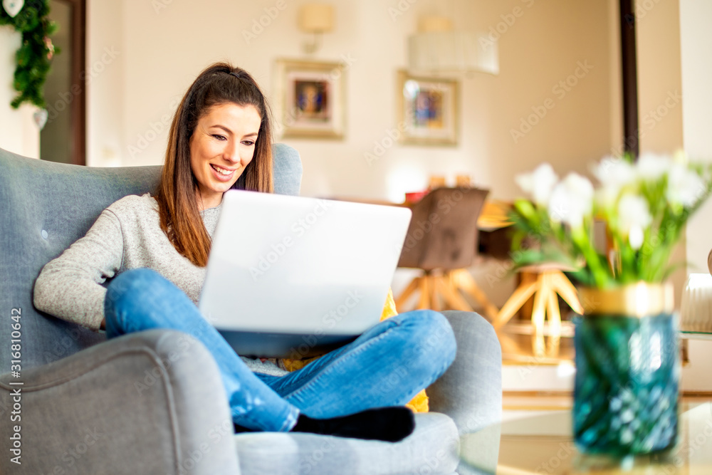 Casual businesswoman using laptop while working online from home Casual businesswoman using laptop while working online from home