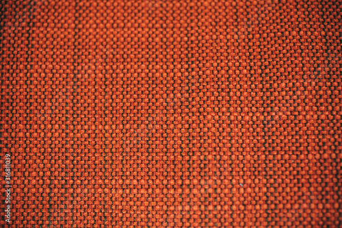 Macro view of orange fabric as texture and background for design. 