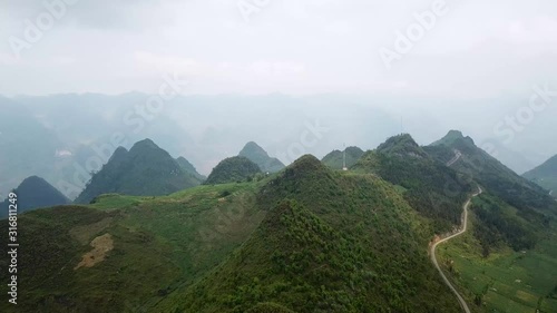 AERIAL: Flight over Green Karst Mountains in the North of the Vietnam photo