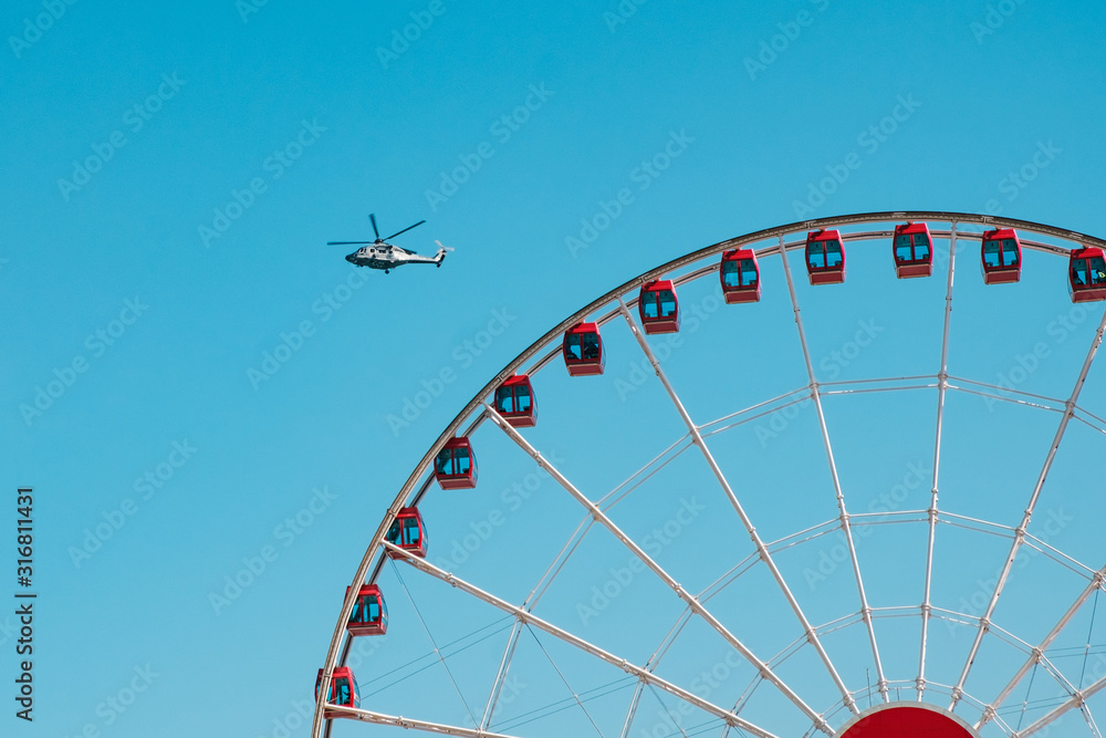 Detail of the Hong Kong observation wheel and Helicopter on blue sky