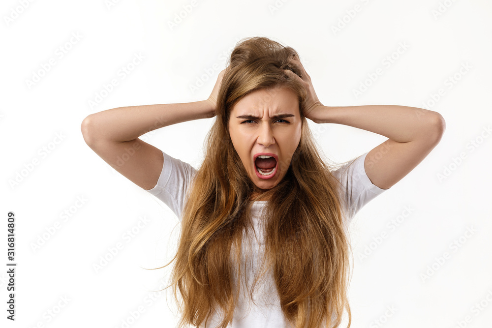 Portrait of young angry woman screaming on white background Portrait of young angry woman screaming on white background