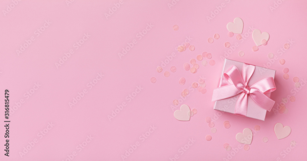 Gift box and confetti hearts. Pink pastel color. Flat lay style. Valentines day concept. Gift box and confetti hearts. Pink pastel color. Flat lay style. Valentines day concept.