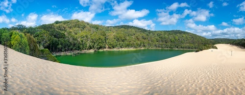 Panorama Lake Wabby on Fraser Island part of the Great Sandy National Park Queensland Australia. The lake is thriving with marine life and will disappear under the sand from The Hammerstone Sandblow. photo