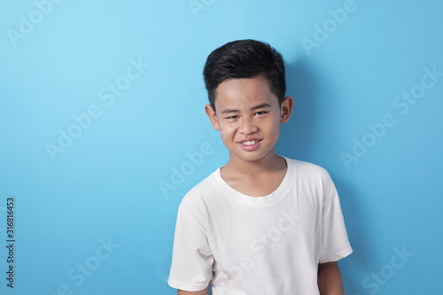 Cute Asian Boy Looking at Camera and Smiling Happily