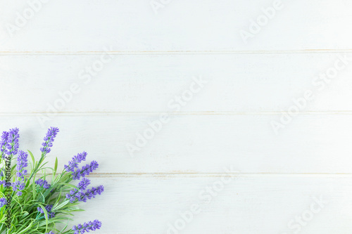 Violet Flowers of Lavender, top view on white Wooden background.