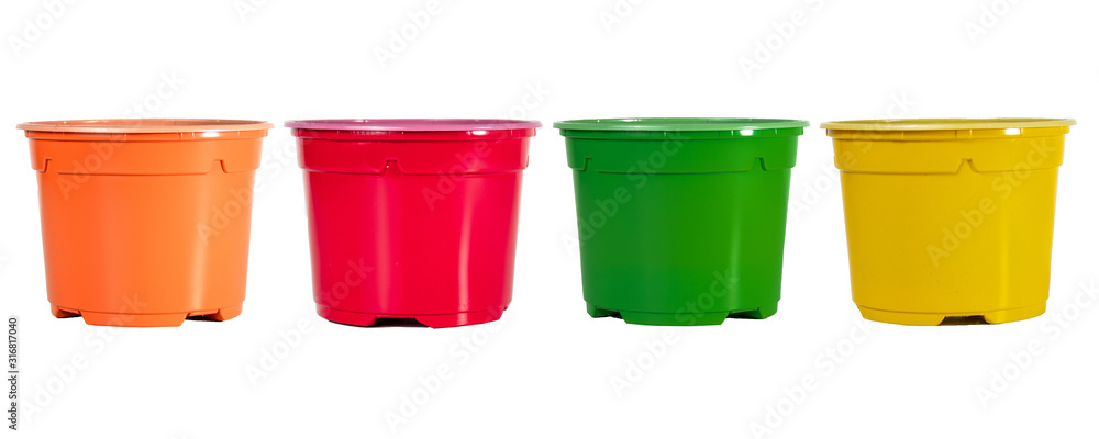 Garden tools on a white background. Shovels, mini rakes and colored pots Garden tools on a white background. Shovels, mini rakes and colored pots