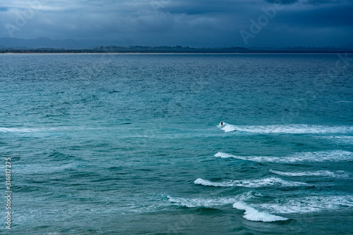 Australian Surfers surf during Storm in the ocean At Byron Bay  New South Wales Australia.