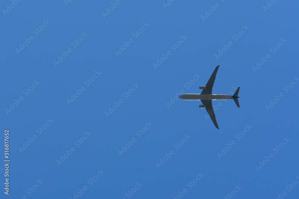 Bottom View of the Airplane in the sky with blank copy space for travel comcept Bottom View of the Airplane in the sky with blank copy space for travel comcept
