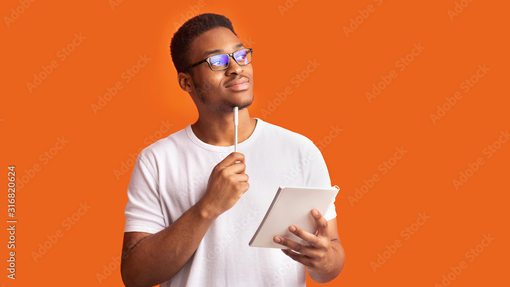 Pensive afro man portrait on orange background - obrazy, fototapety, plakaty 