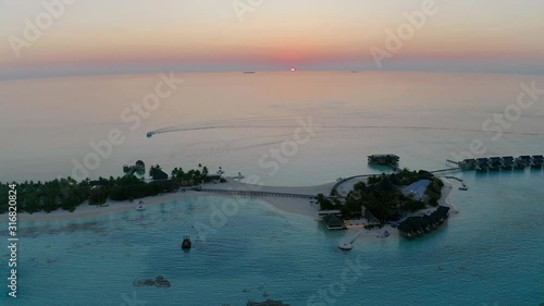 Aerial view, Flight at Lagoon of the Maldives island Maadhoo at dusk, South Male Atoll, Maldives photo