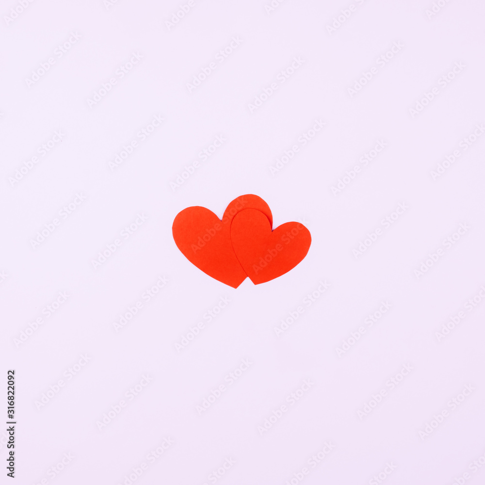 Two red hearts on a pink background. Postcard for beloved