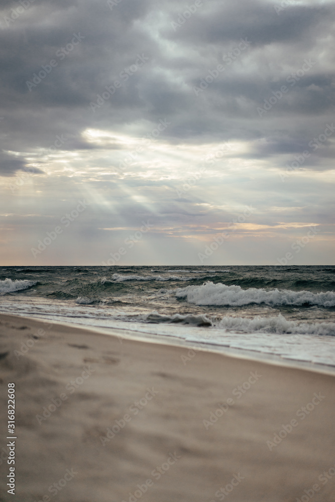 Late summer sunset on the Baltic sea coastline. Landscape of a beach near Ustka, Poland.