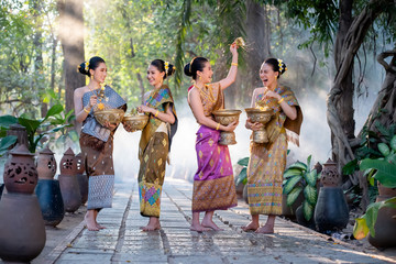 Beautiful Asian woman splashing water during tradition festival Thai,Songkran festival.