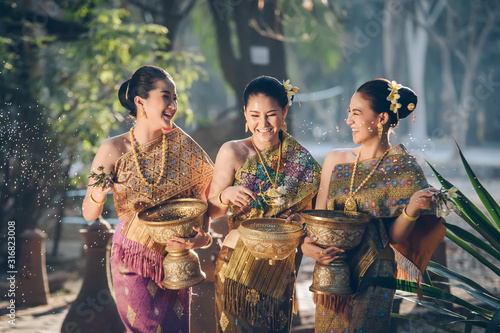 Photos Beautiful Asian woman splashing water during tradition festival Thai,Songkran festival