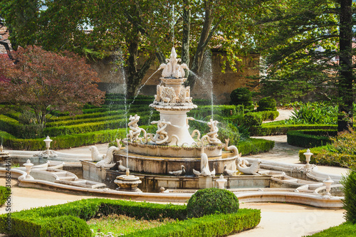 an antique fountain in the park in Lisbon
