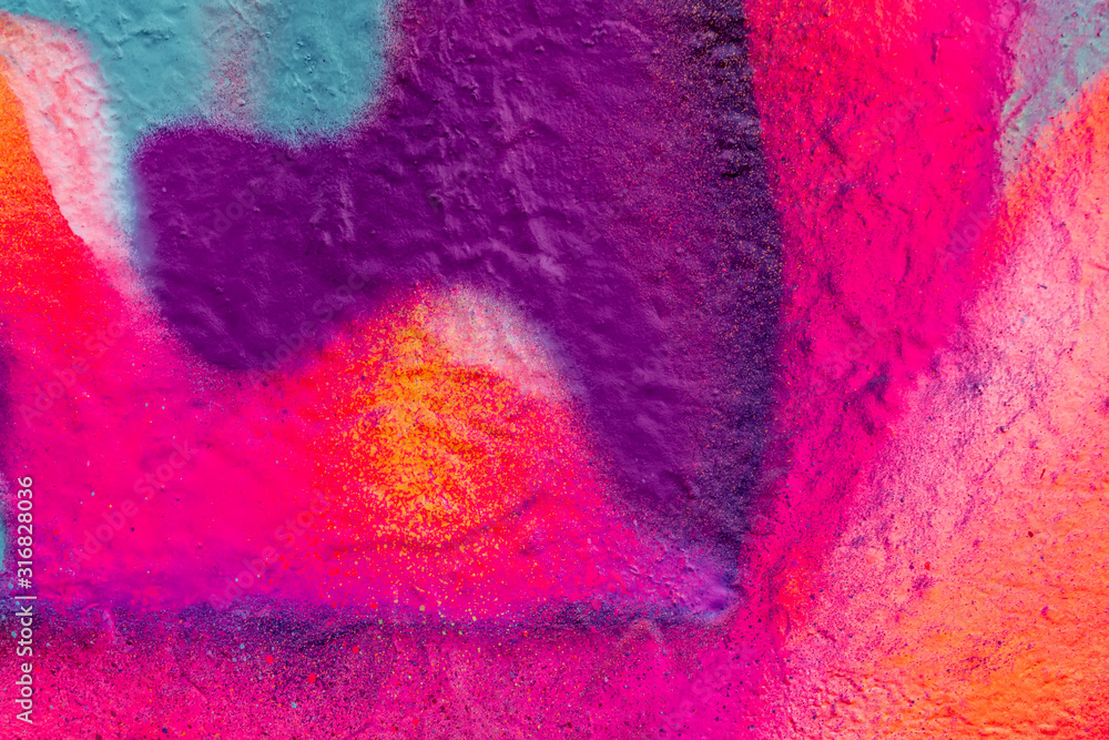Fototapeta premium Beautiful bright colorful street art graffiti background. Abstract creative spray drawing fashion colors on the walls of the city. Urban Culture, pink , red , orange , yellow, crimson , purple texture