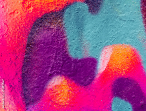 Beautiful bright colorful street art graffiti background. Abstract creative spray drawing fashion colors on the walls of the city. Urban Culture, pink , red , orange , yellow, crimson , purple texture