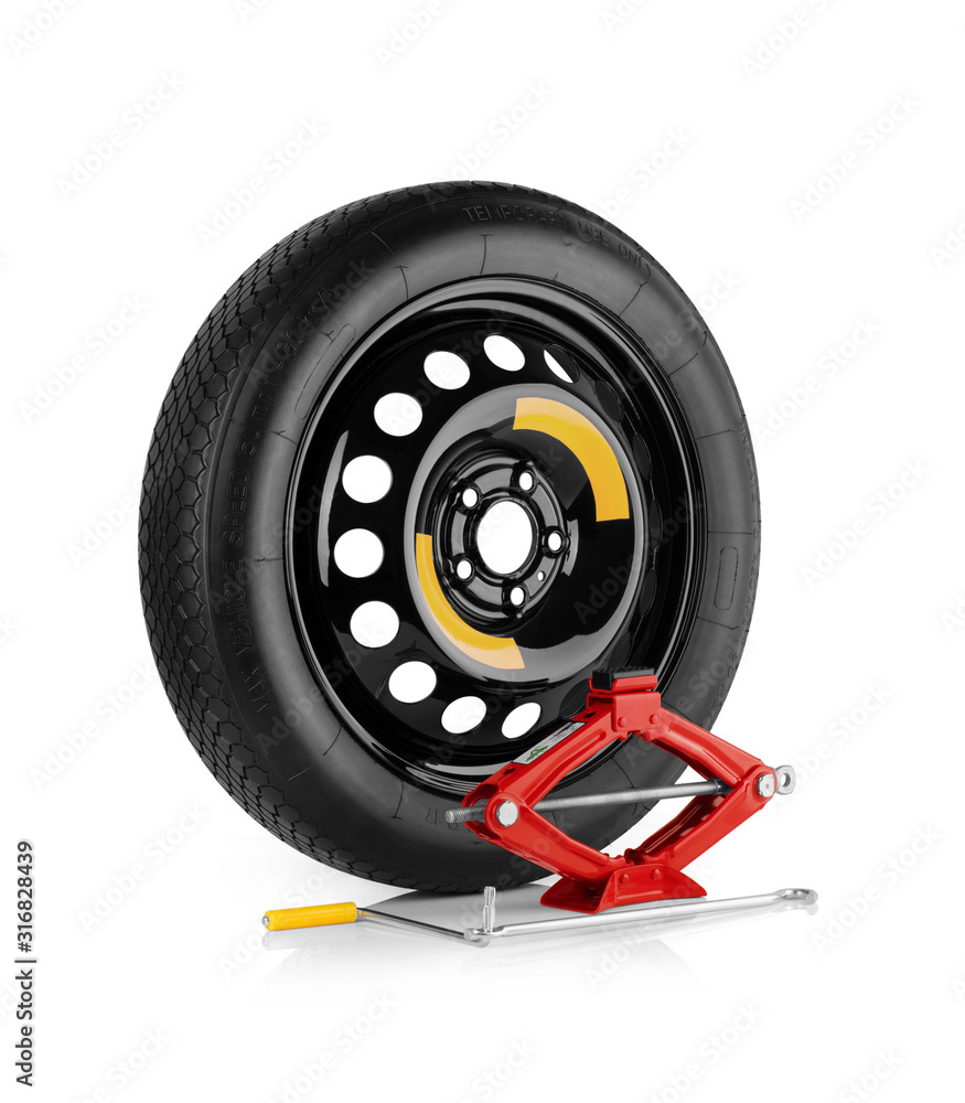 Fototapeta premium Spare wheel and car jack isolated on white background