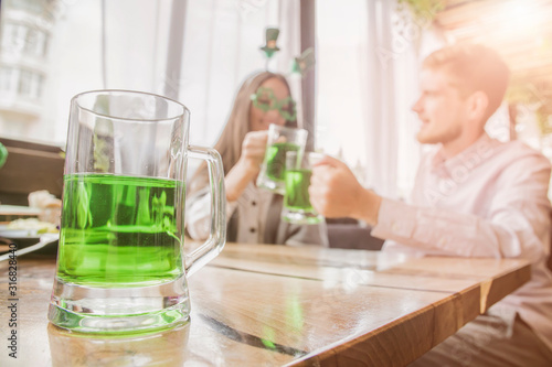 Group of friends celebrating St. Patrick's Day at a pub