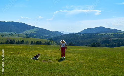 Woman and dog in a wonderful mountain landscape in spring © branislav