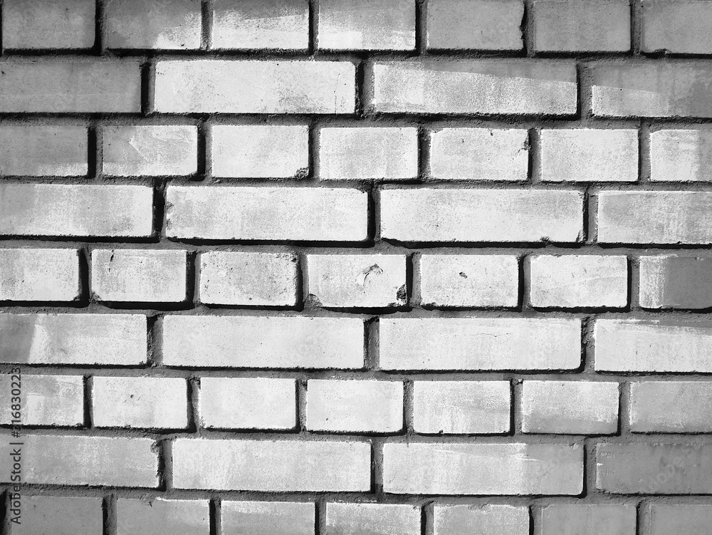 Obraz premium Brick wall with a white spot in the center of the image, background