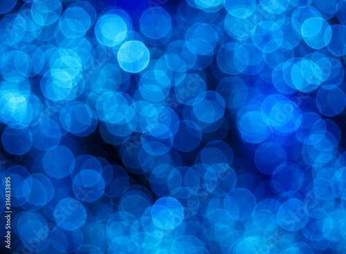 Blurry abstract pattern with glowing blue light spots. Decorative background for holidays