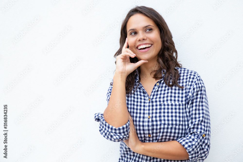 Content young woman with hand on cheek. Beautiful cheerful young woman standing with hand on face and looking away on white background. Happiness concept Content young woman with hand on cheek. Beautiful cheerful young woman standing with hand on face and looking away on white background. Happiness concept