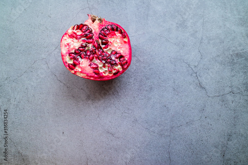Isolated pomegranate on concrete background.