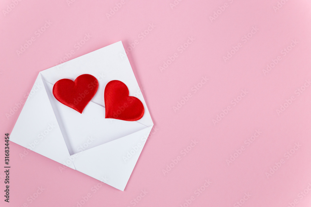 red hearts spill out of a white paper envelope red hearts spill out of a white paper envelope